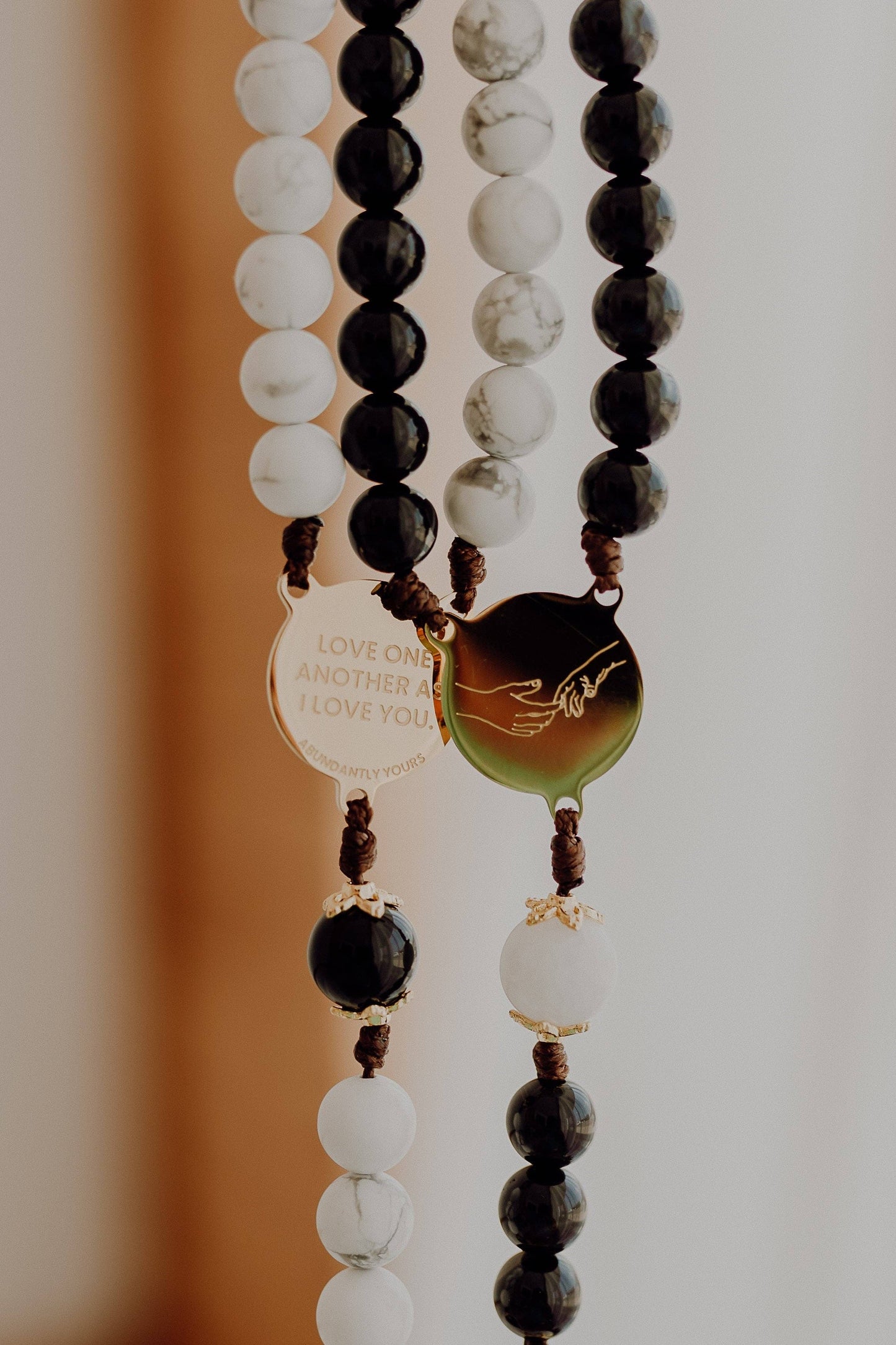 Close-up of a beaded rosary with a focus on the beads and a blurred background