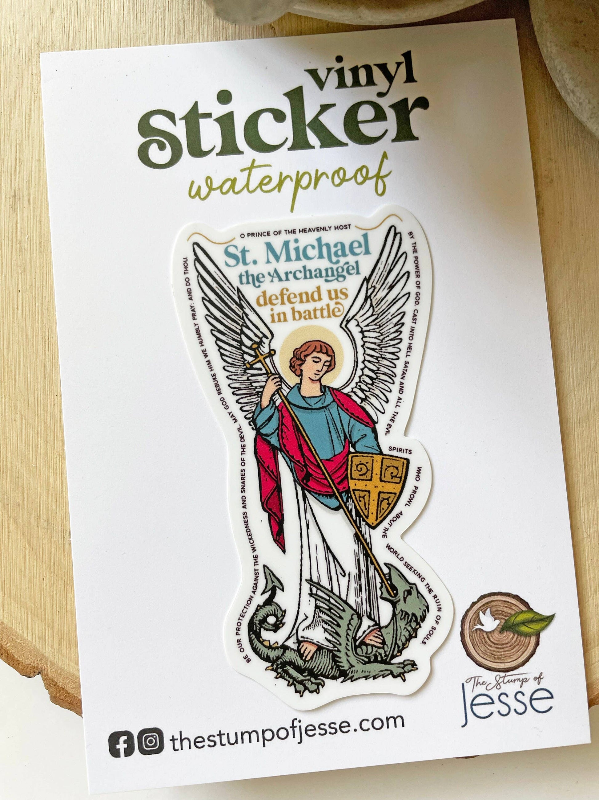 Sticker of St. Michael the Archangel on a white card with branding information.