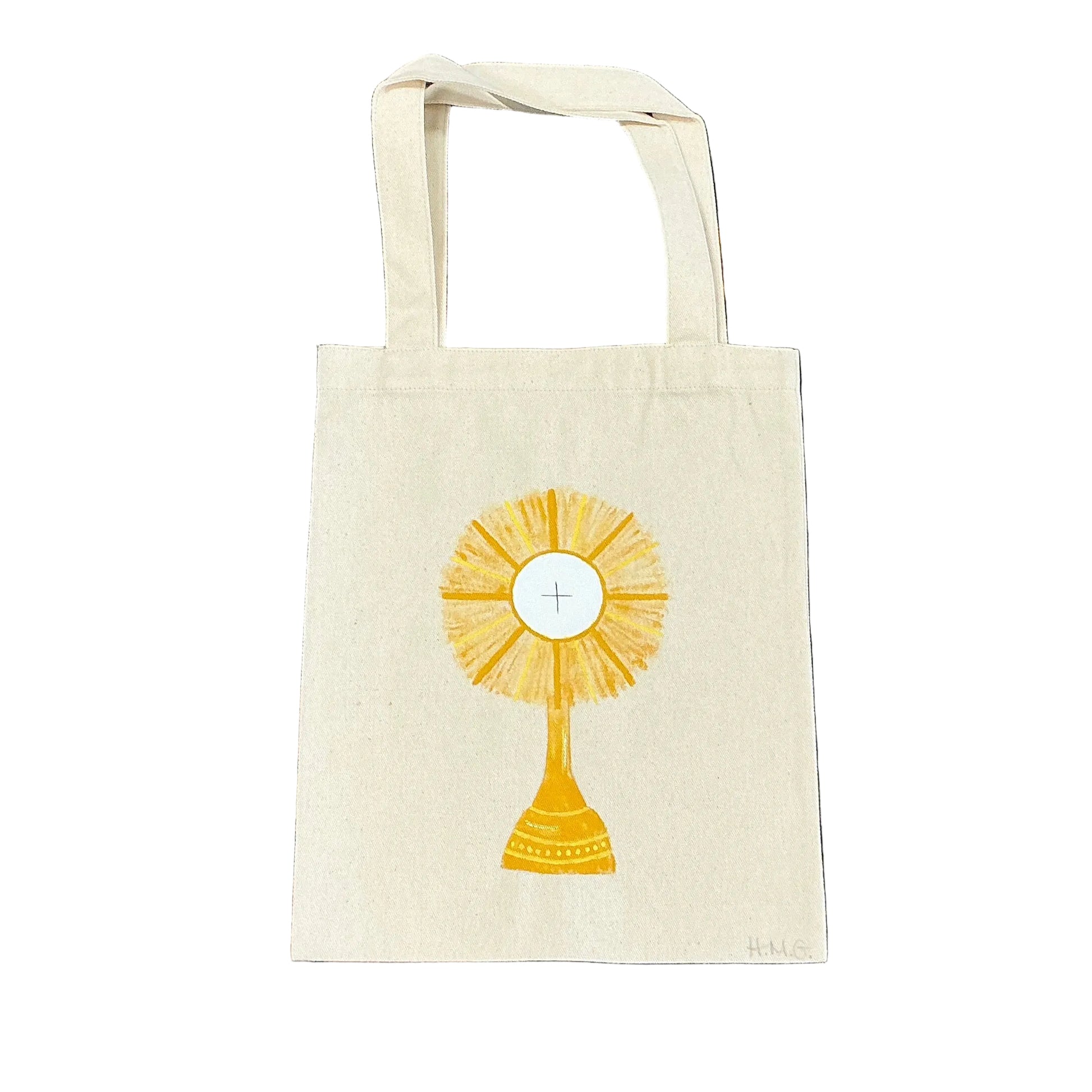 Small white bag with a monstrance design on a floral patterned fabric background