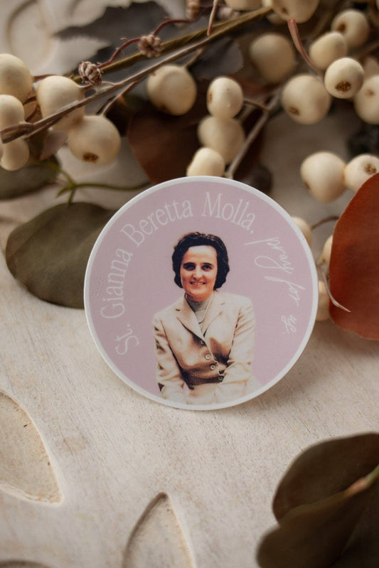 Circular photo of a woman on a decorative plate with white berries and leaves in the background