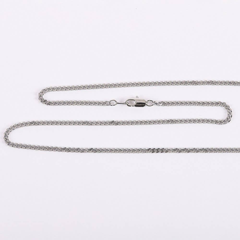 Silver chain necklace on a light gray background