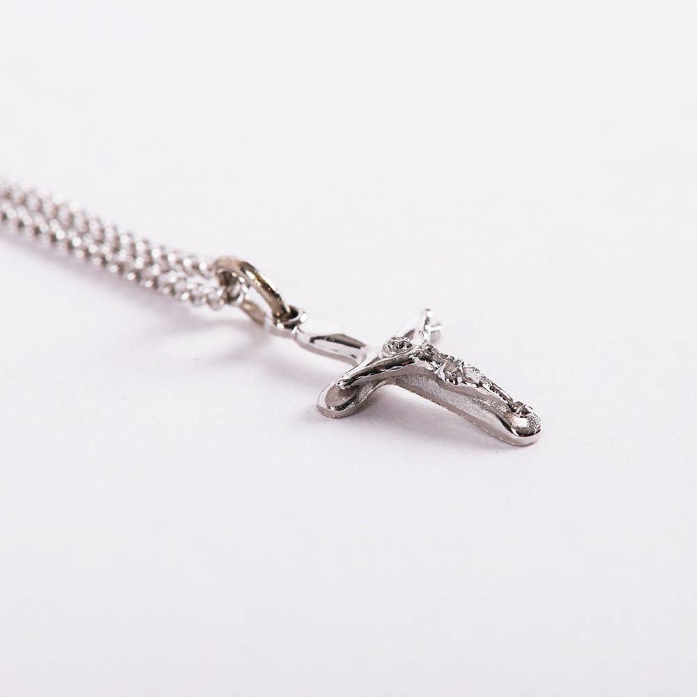 Silver cross necklace on a white background