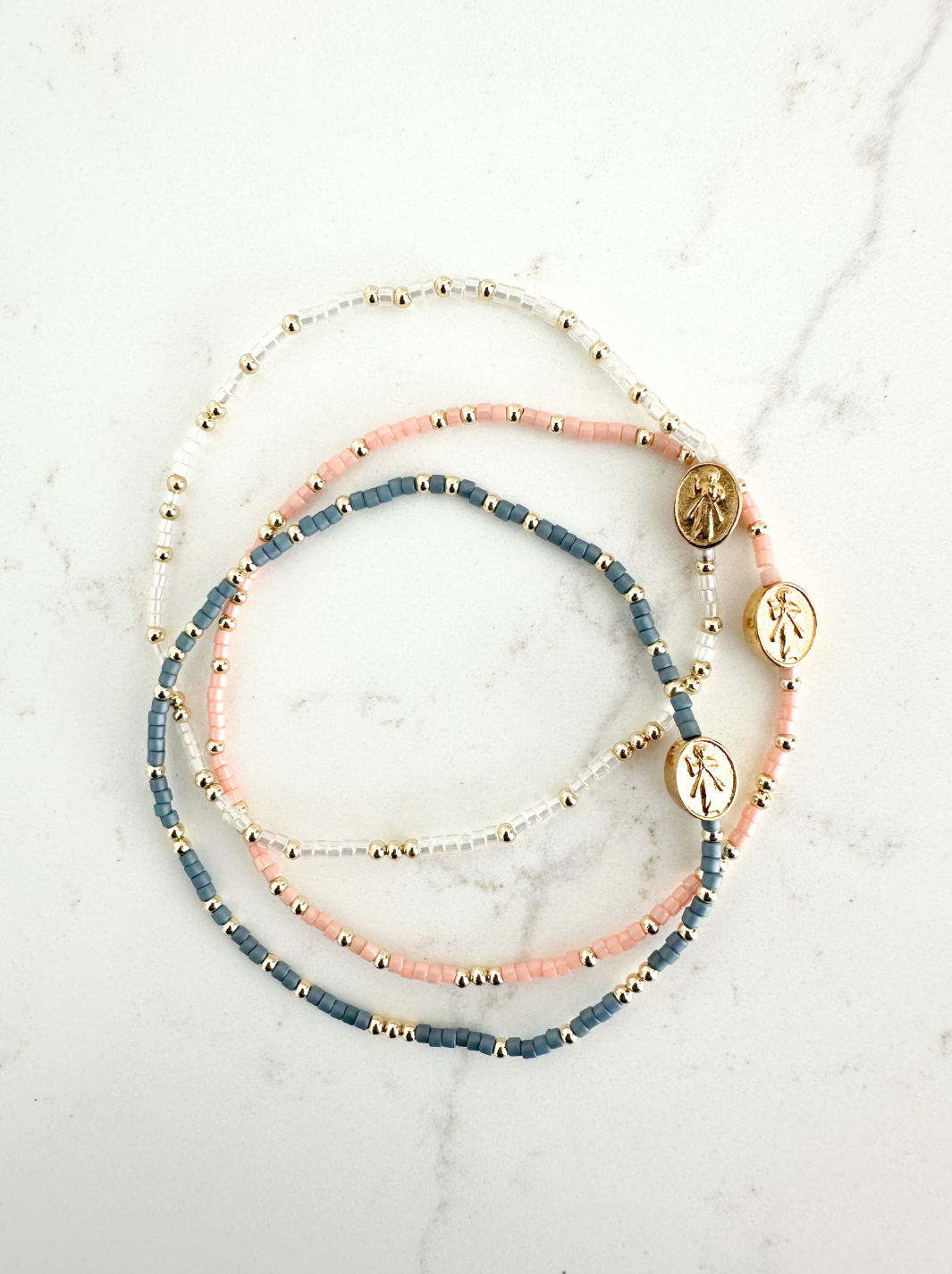 Set of beaded bracelets on a marble surface