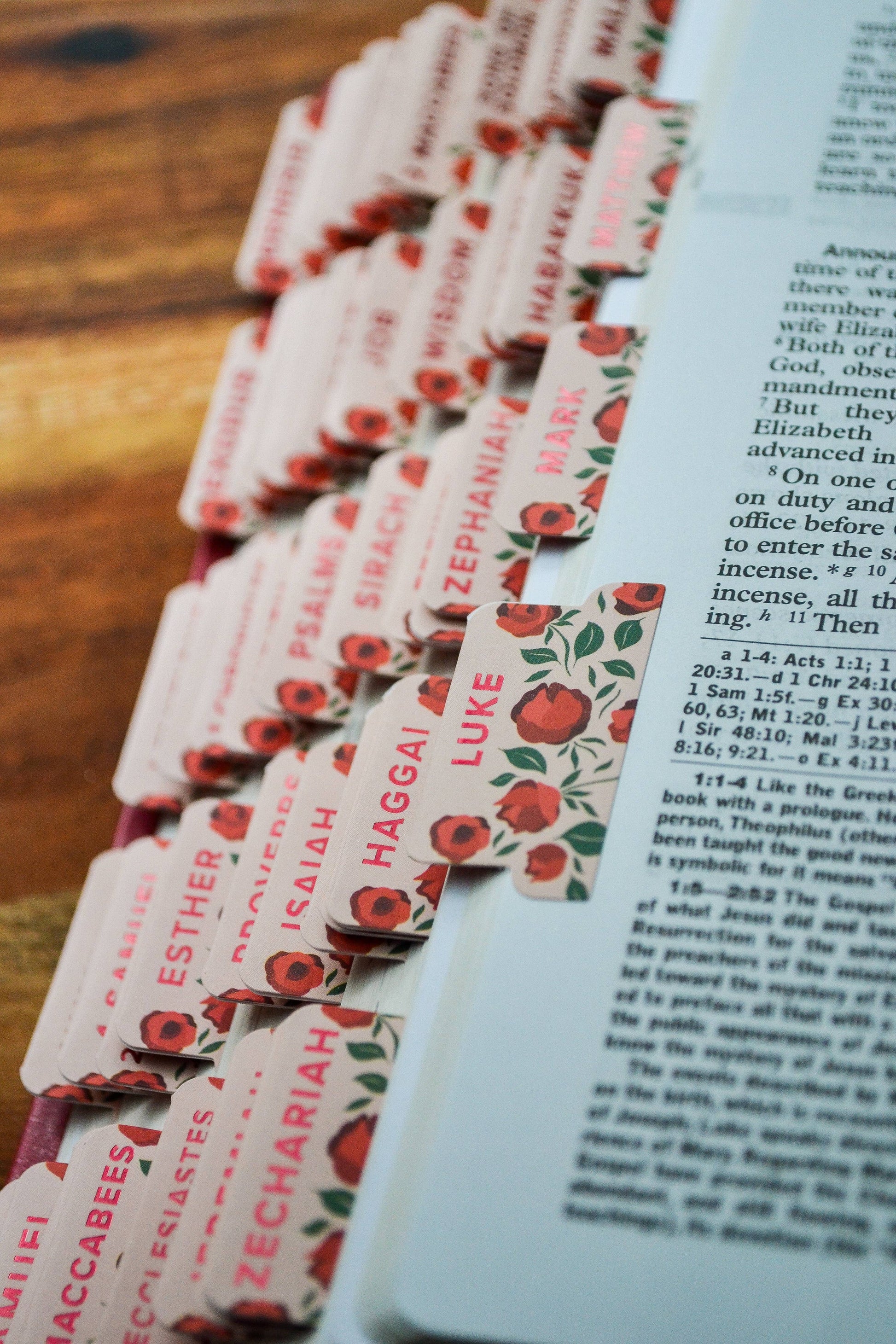 Set of prayer cards with floral design on a wooden surface