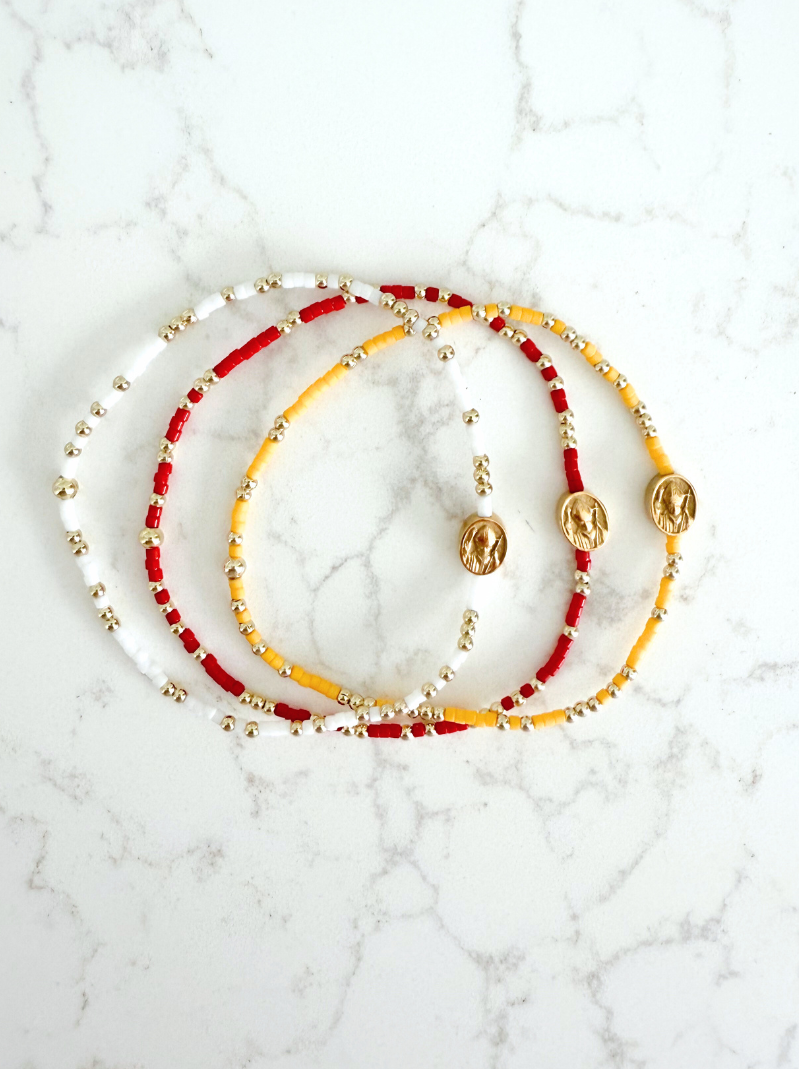 Set of beaded necklaces on a marble surface