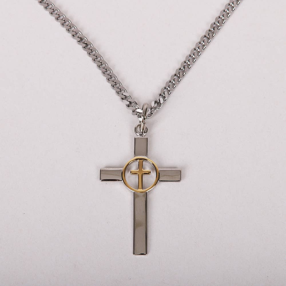 Cross-shaped pendant with gold center on a chain against a light gray background