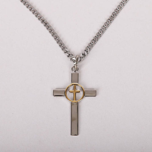 Cross-shaped pendant with gold center on a chain against a light gray background