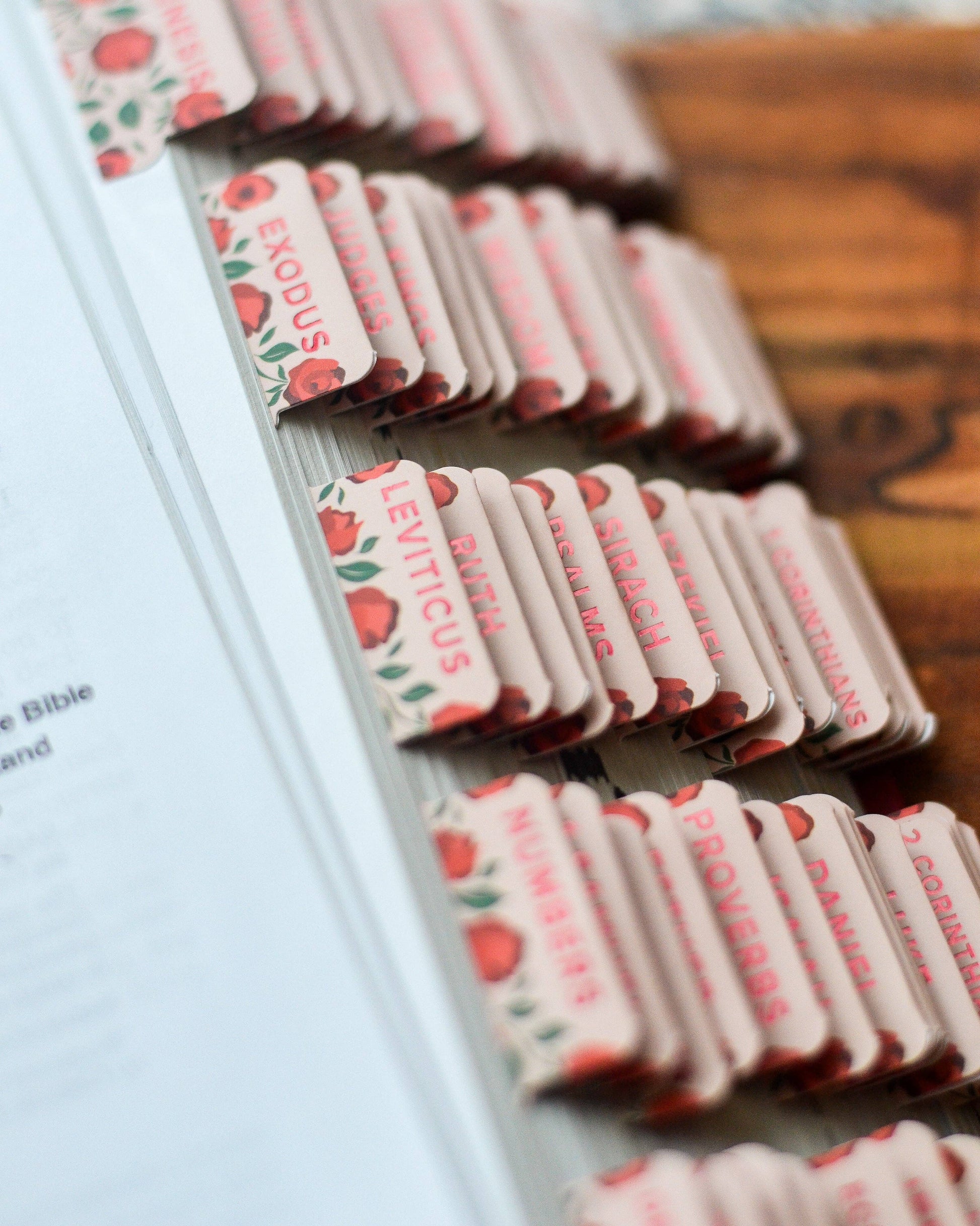 Set of book markers with religious text and illustrations on a wooden surface