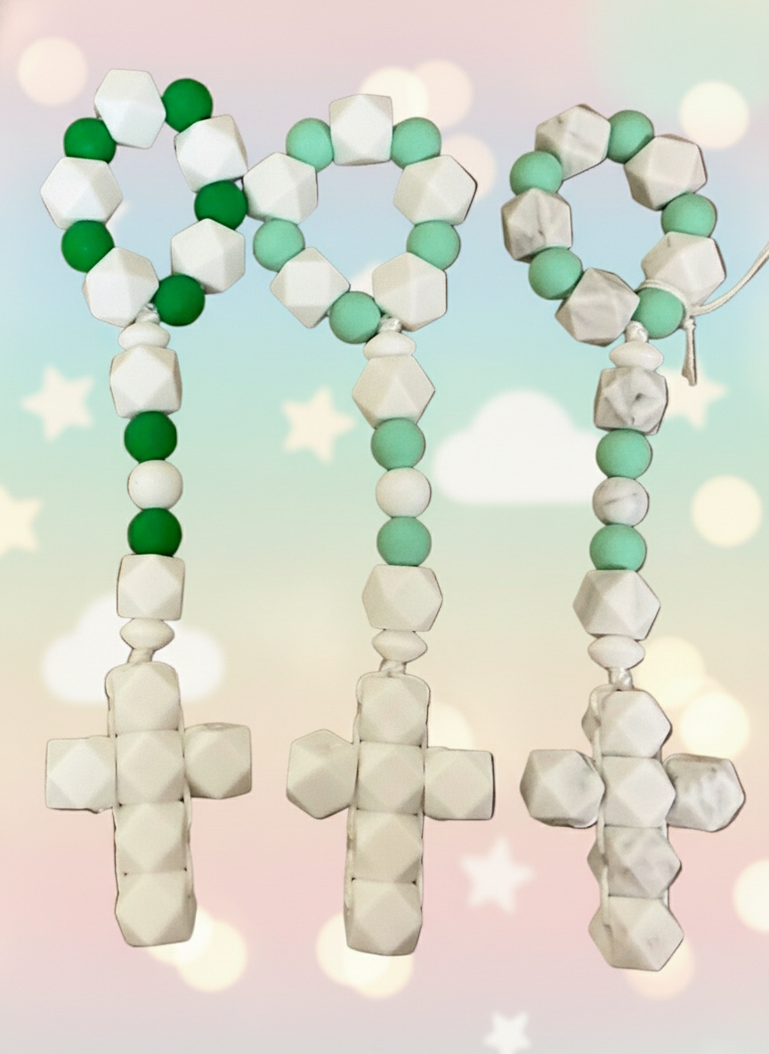 Decorative rosary with crosses and beads on a gray background