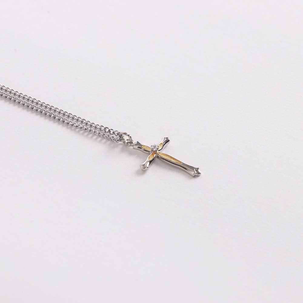 Silver chain necklace with a cross pendant on a white background