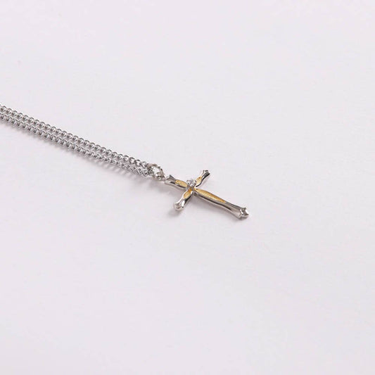 Silver chain necklace with a cross pendant on a white background