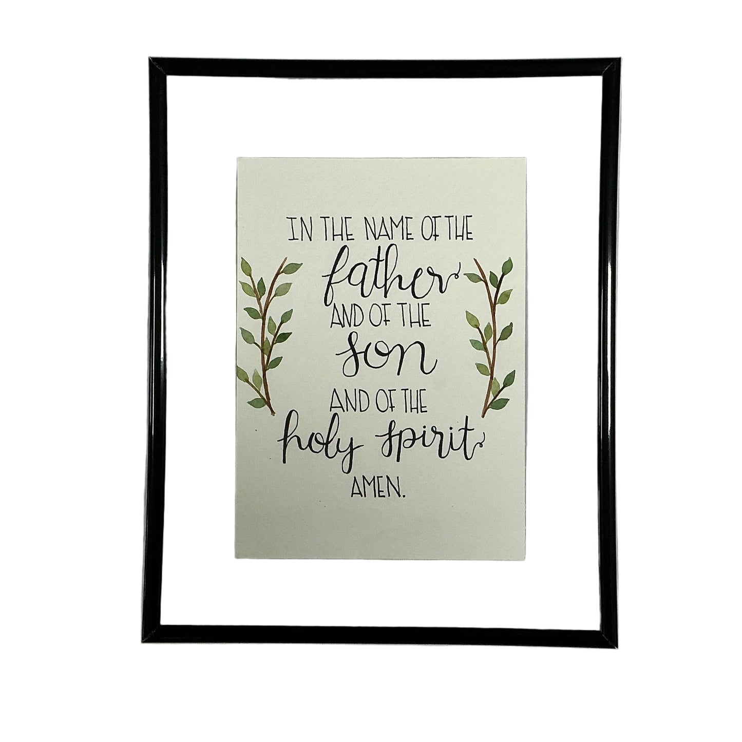 Framed print with religious text and leaves on a white fabric background