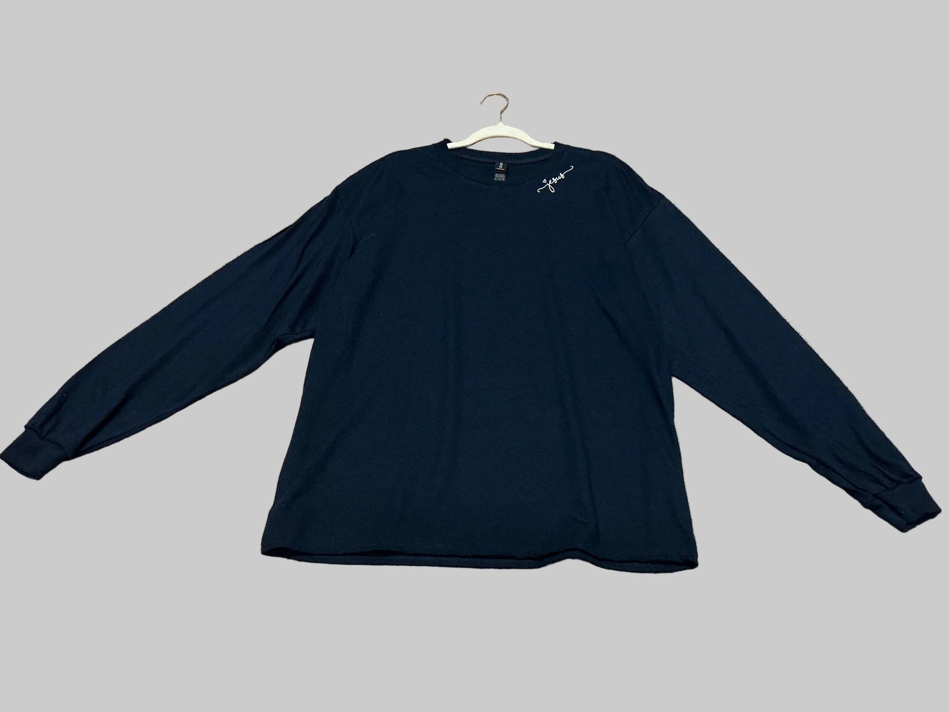 Navy blue long-sleeve shirt on a grey background 