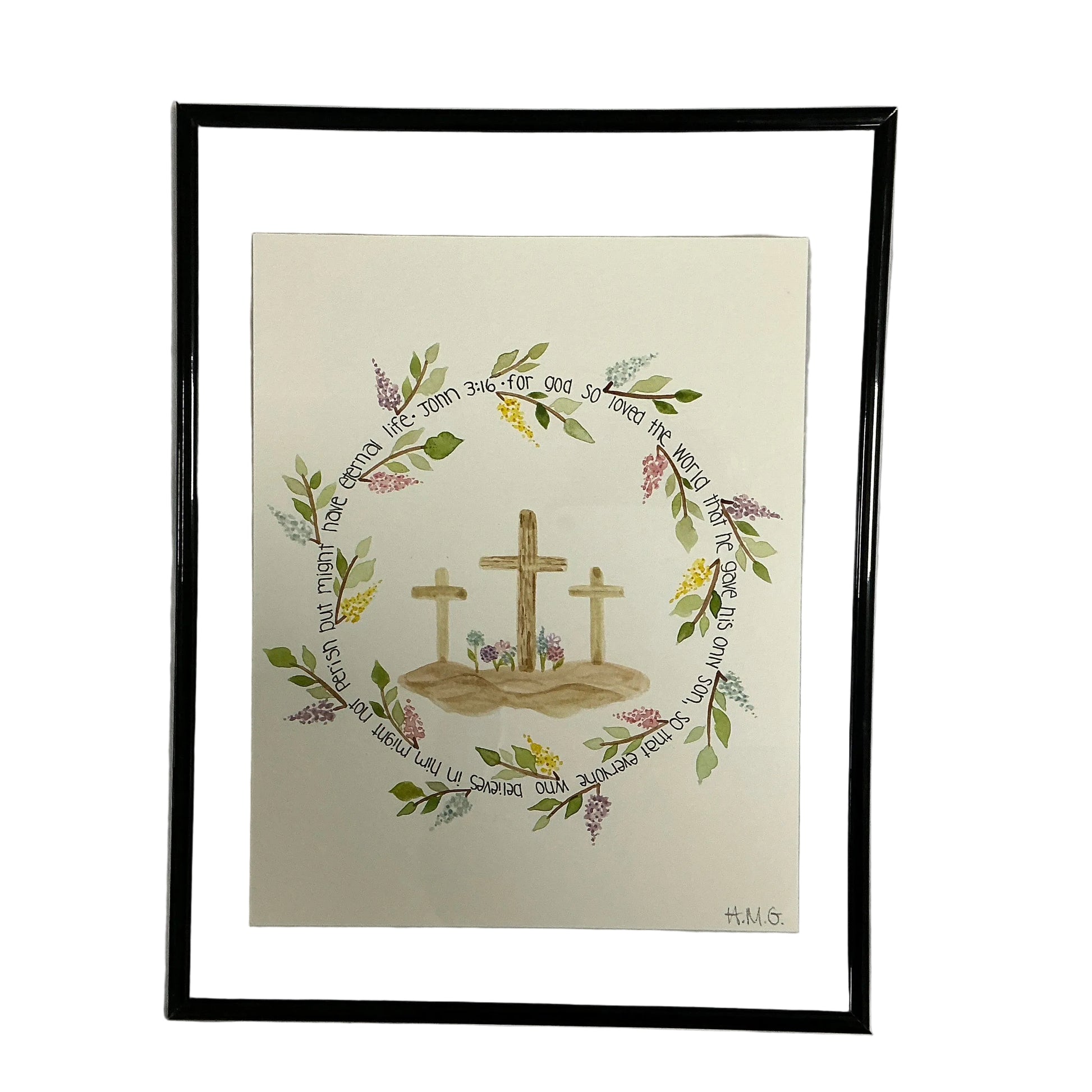Framed artwork with crosses and floral wreath on a white background