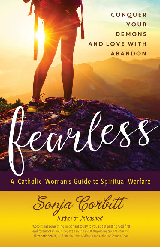 Book cover for 'Fearless: A Catholic Woman's Guide to Spiritual Warfare' by Sonja Corbitt, featuring a hiker's legs against a glowing sunrise over mountains, with the title in large white script and the author's name on a yellow band at the bottom.