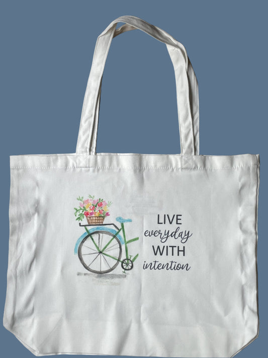 Tote bag with bicycle and flower design on a blue background