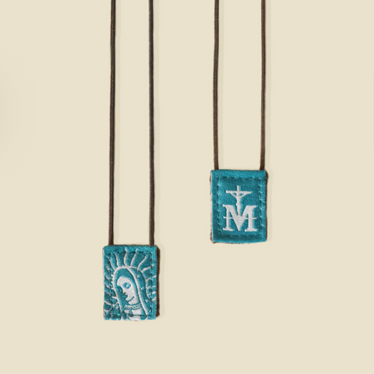 Scapular with embroidered designs on a beige background