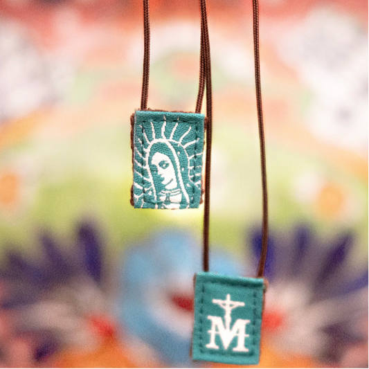Green scapular of Our Lady of Guadalupe with designs on a blurred background