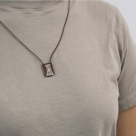 Scapular displayed on a person wearing a gray shirt