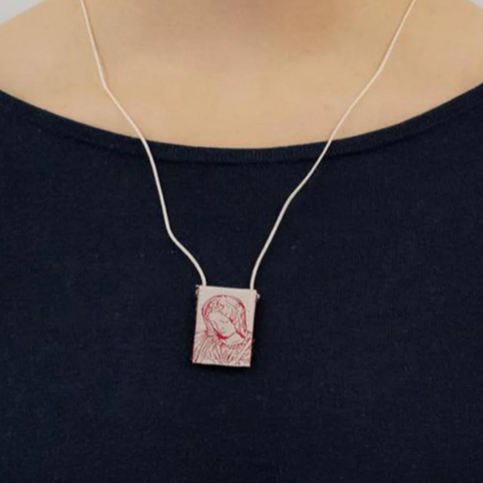 Scapular with Our Lady featuring a red design on a black shirt