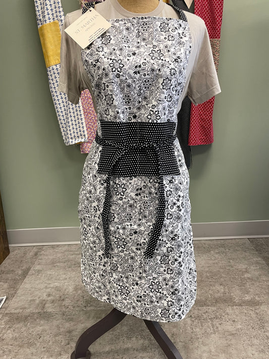 Silver apron with black belt on a mannequin against a neutral background