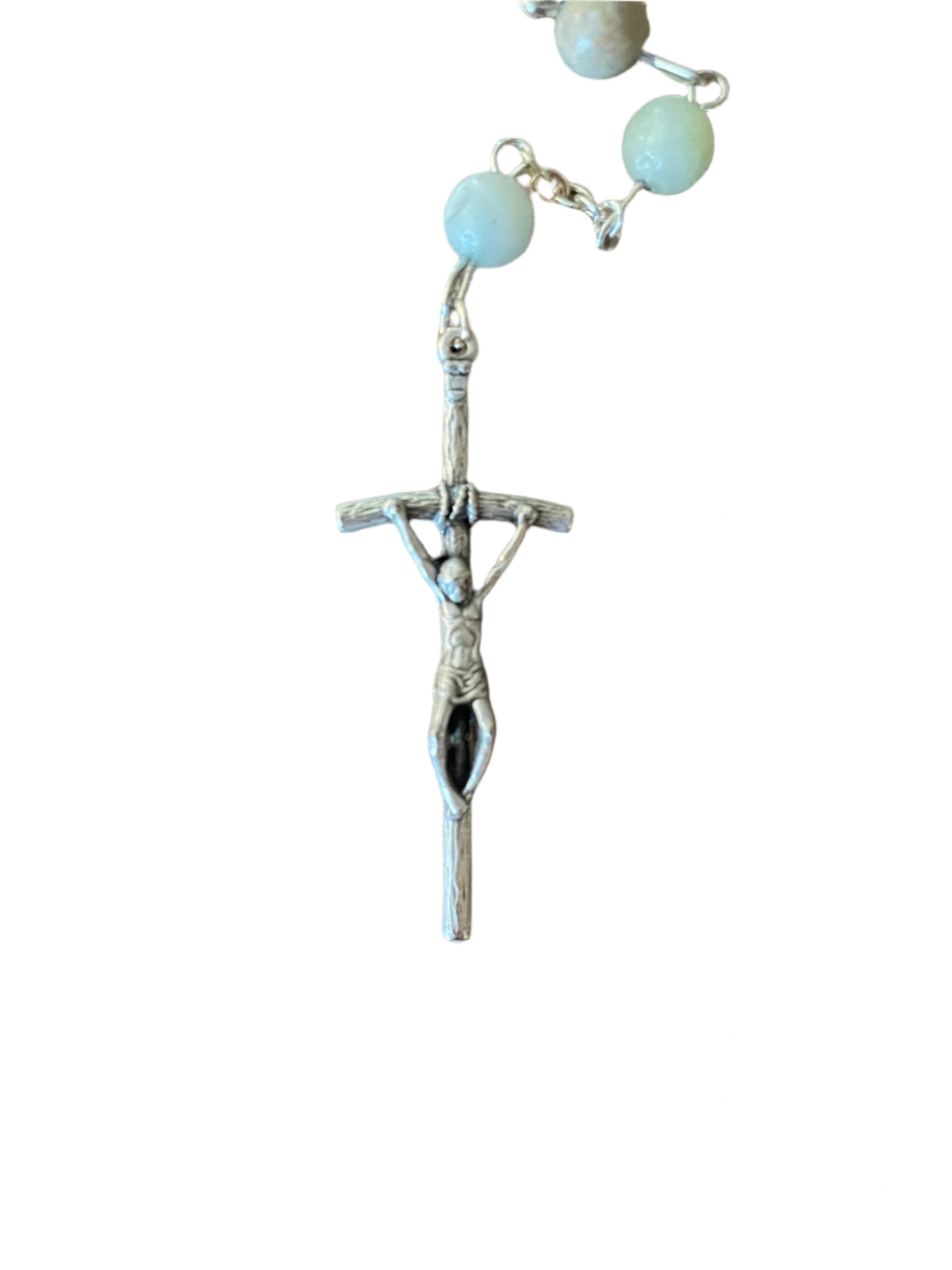 Silver rosary with a pendant on a wooden surface
