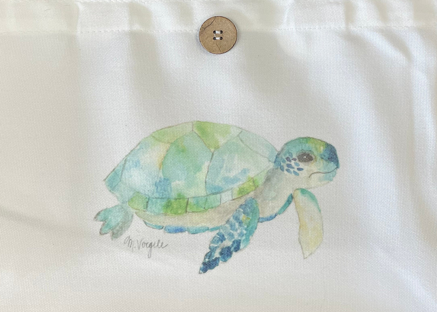 Tote bag with a turtle design on a gray couch
