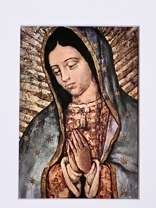 Religious icon of a woman with a dark headscarf and patterned garment on a light blue background