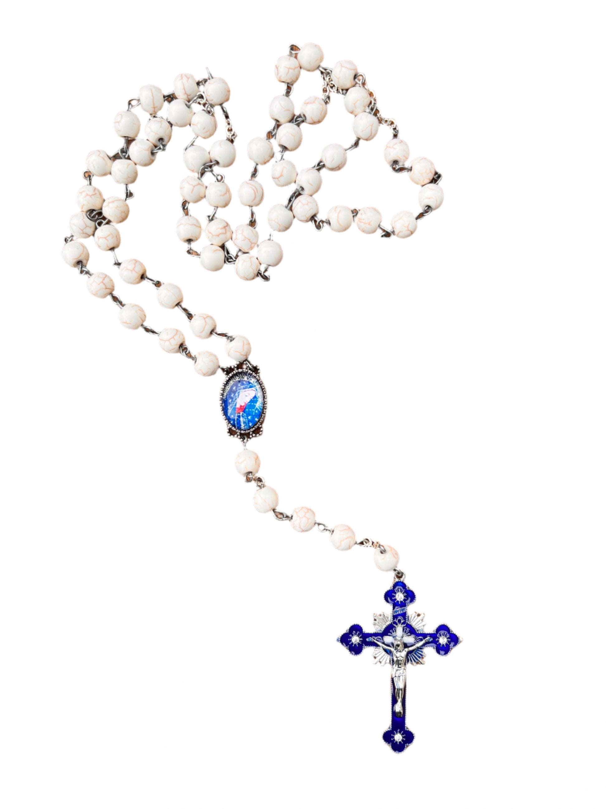 White rosary with blue and silver accents on a white background