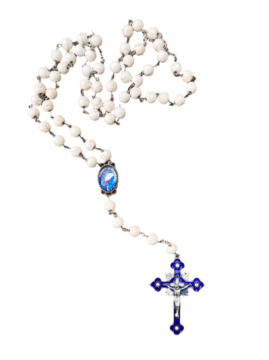White rosary with blue and silver accents on a white background