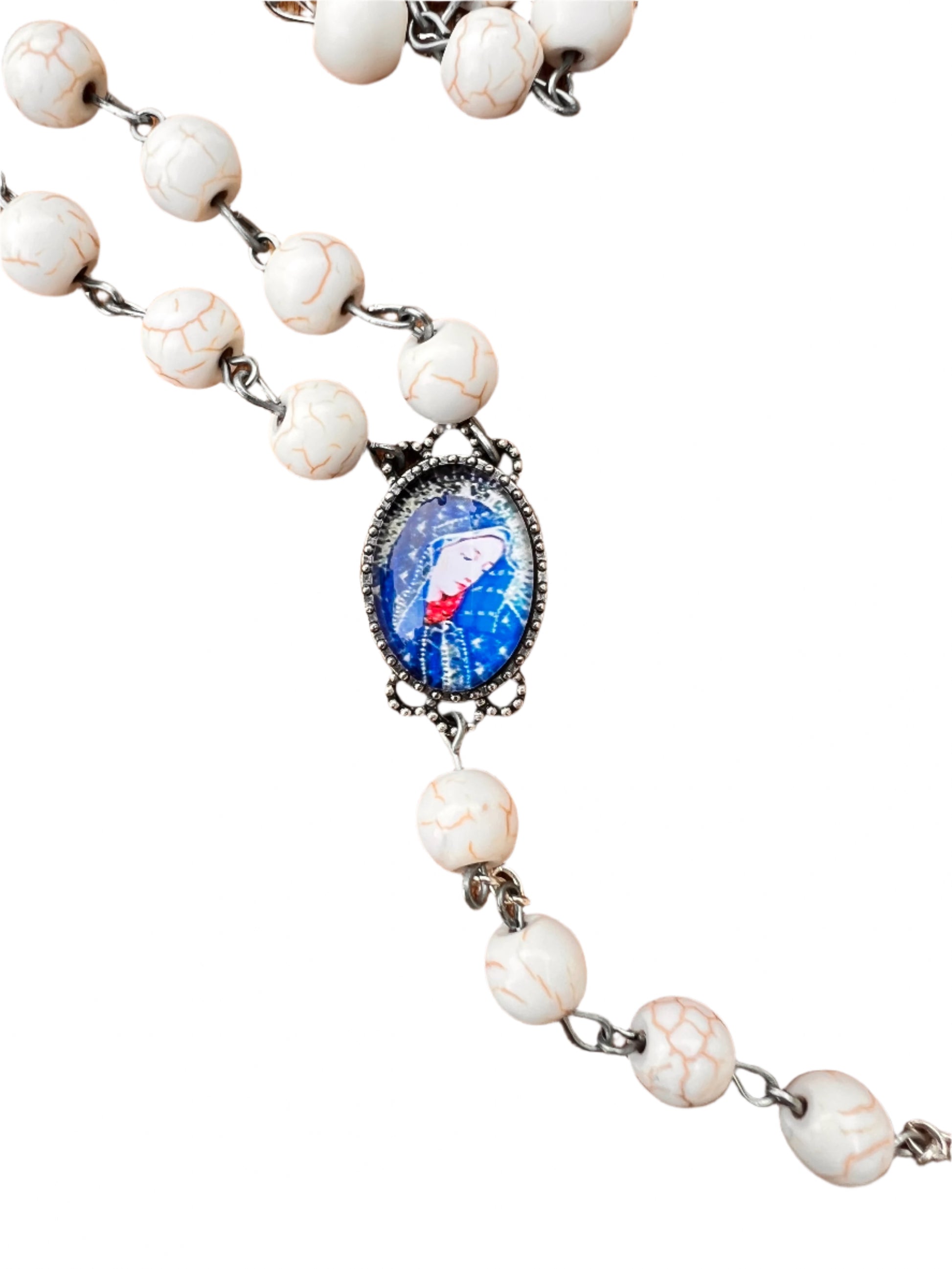 Rosary with white beads and a central blue pendant on a white background