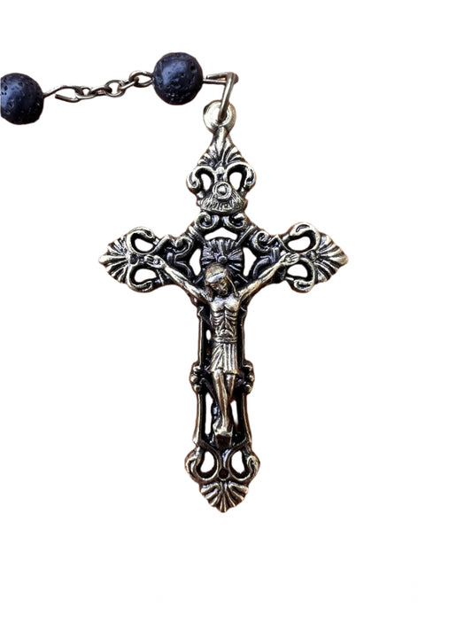 Decorative crucifix with black beads on a white background