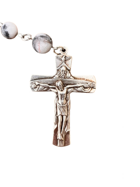 Silver crucifix with Jesus on a wooden surface
