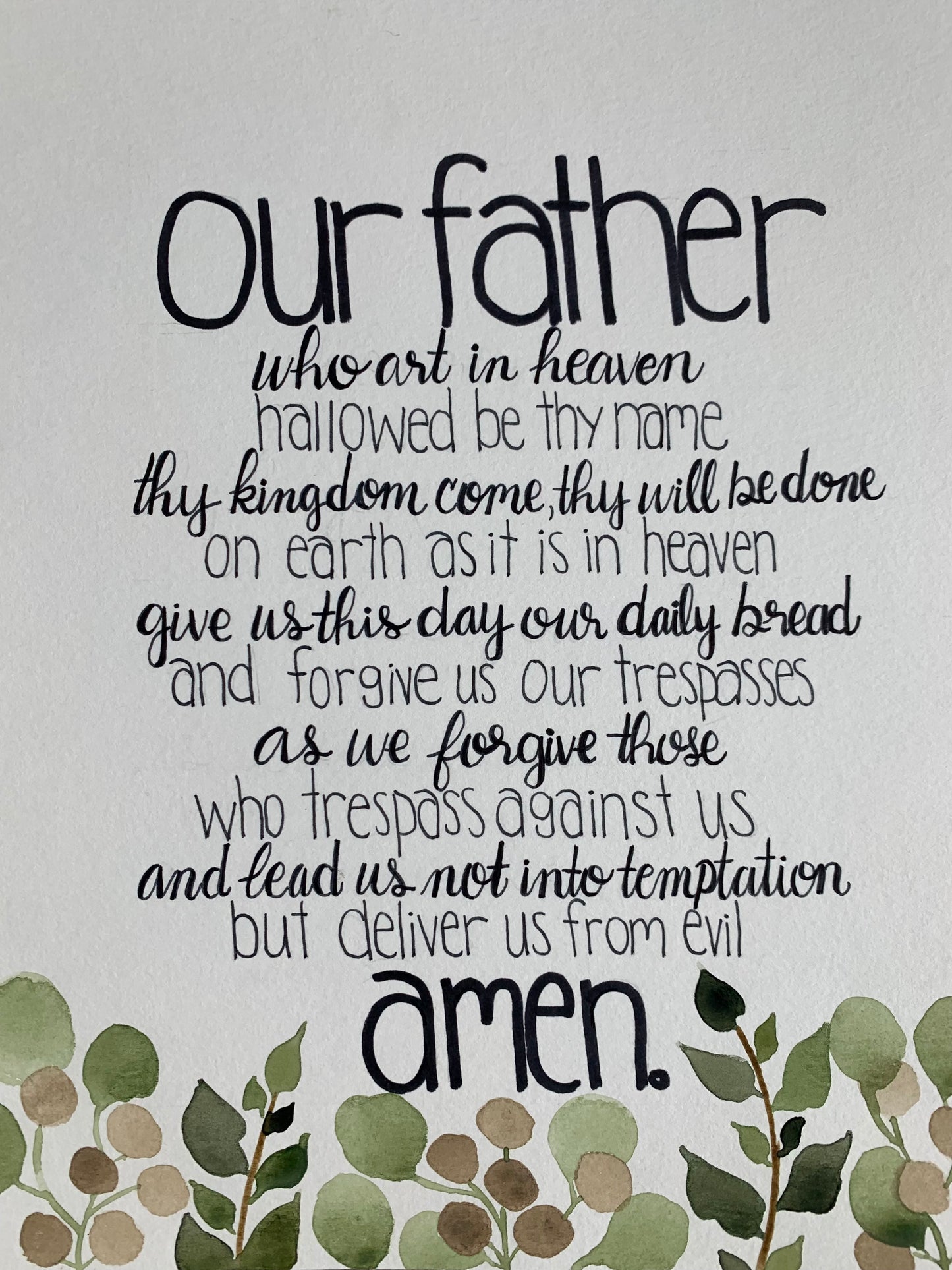 Text of the Lord's Prayer with decorative leaves on a light background