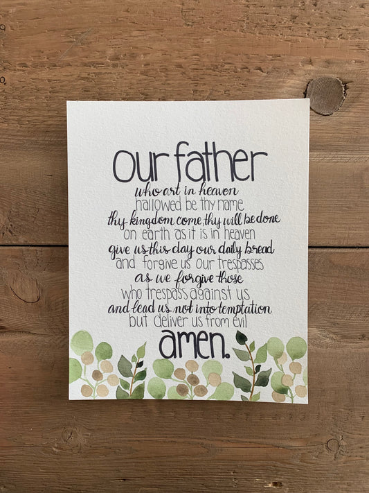 Print of the Lord's Prayer with decorative elements on a wooden background