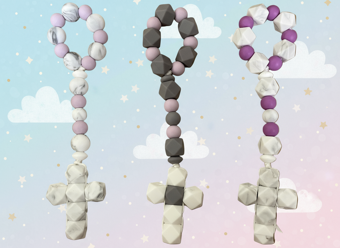 Three decorative crosses made of bead-like material on a brown background