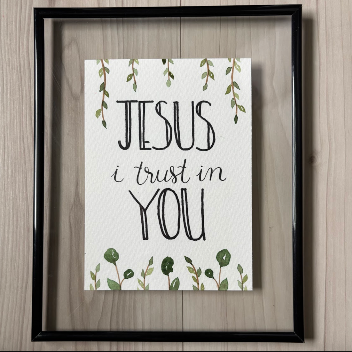 Framed print with 'Jesus I trust in you' text 
