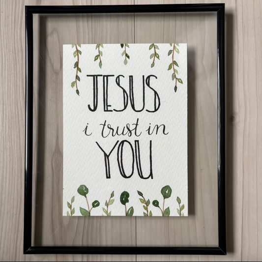 Framed print with 'Jesus I trust in you' text 