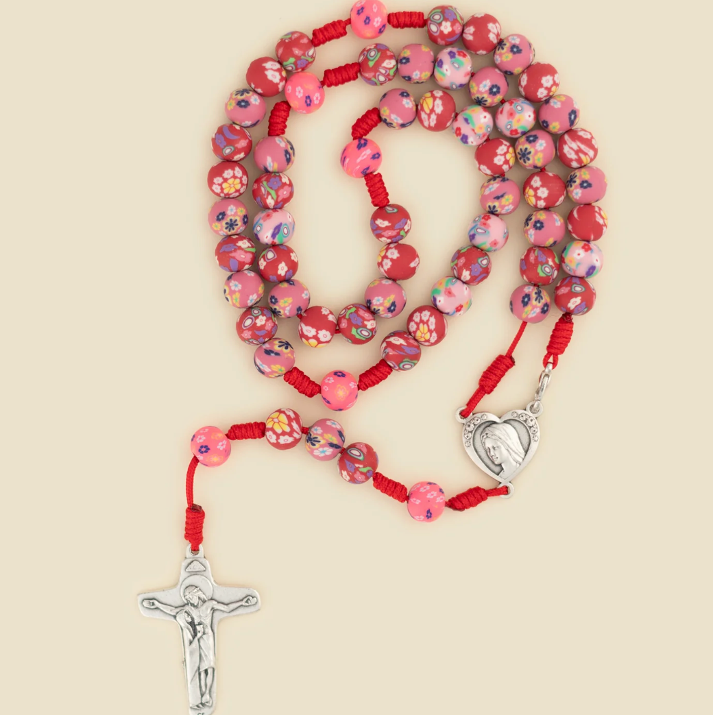 Red rosary on white background 