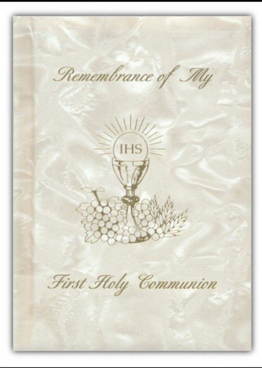 First Holy Communion book with chalice and grapes design on a textured beige background