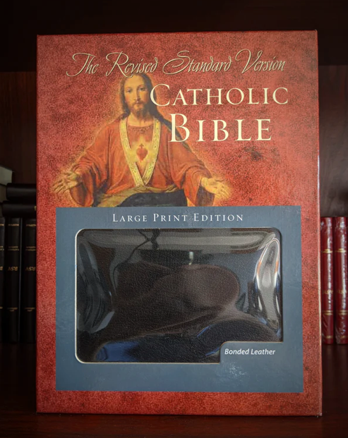 Catholic Bible with large print edition packaging featuring an image of Jesus on a red background.