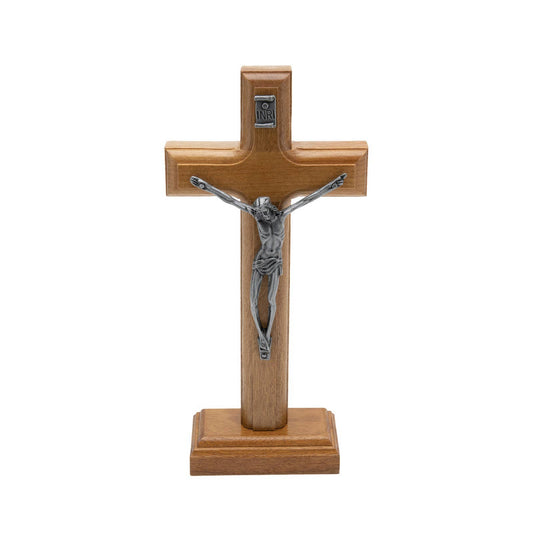 Wooden cross with silver Jesus figure on a white background