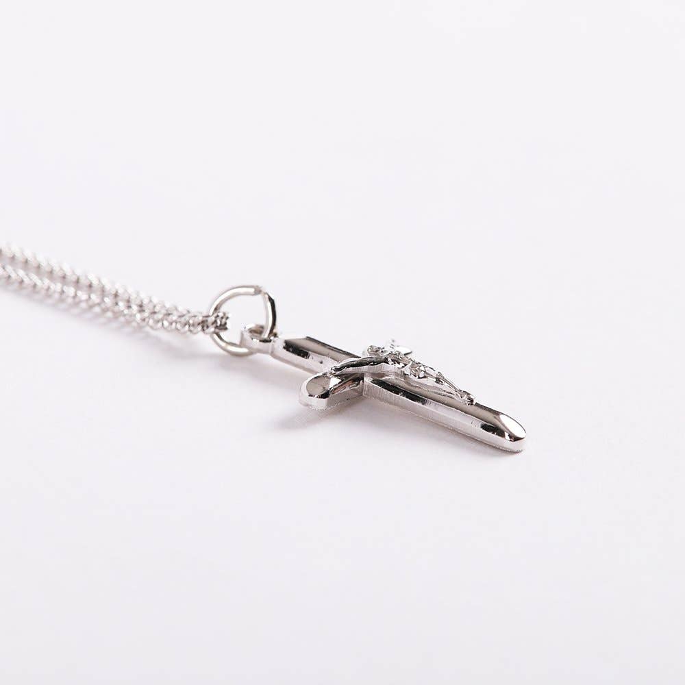 Silver cross necklace on a white background