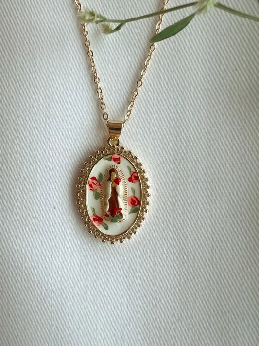 Gold necklace with a pendant featuring a religious design on a white background