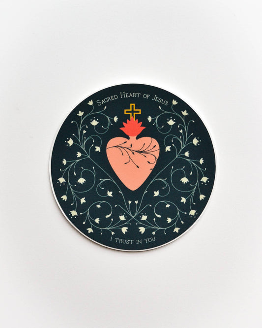 Circular coaster with Sacred Heart of Jesus design on a white background