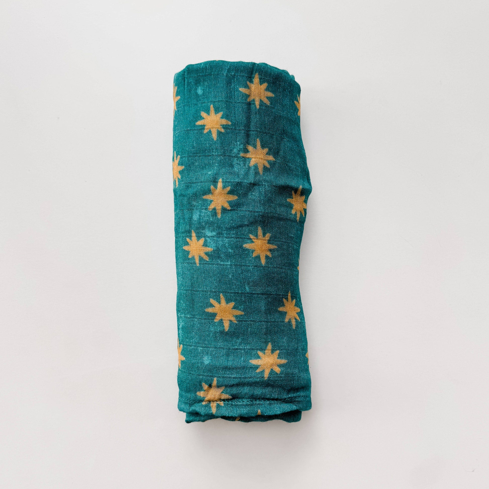 Rolled-up fabric with star patterns on a white background