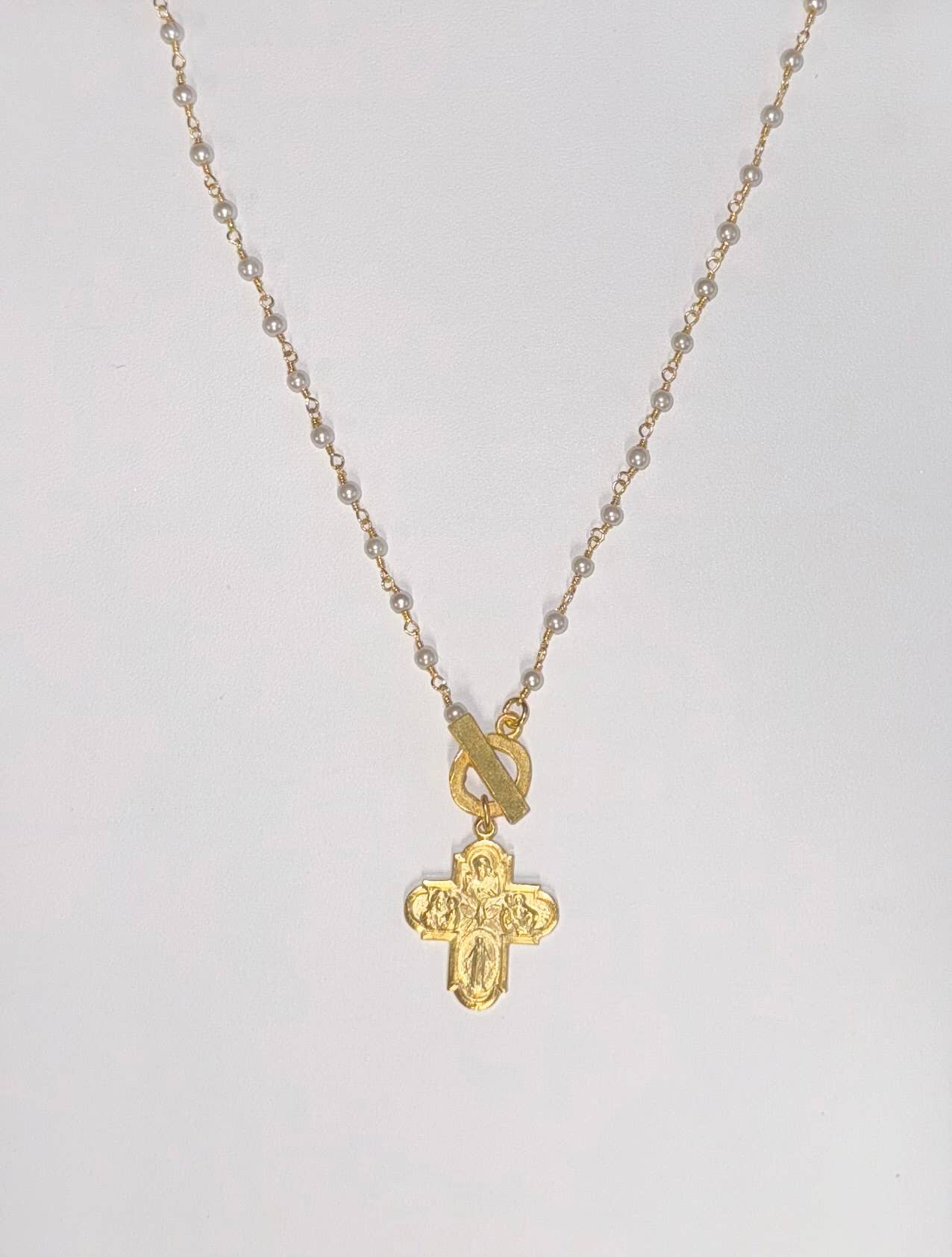 Gold cross necklace with engraved design