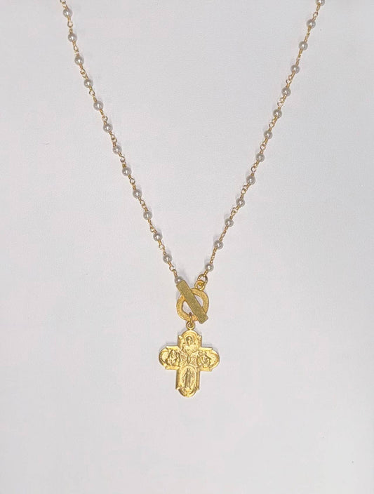 Gold cross necklace with engraved design