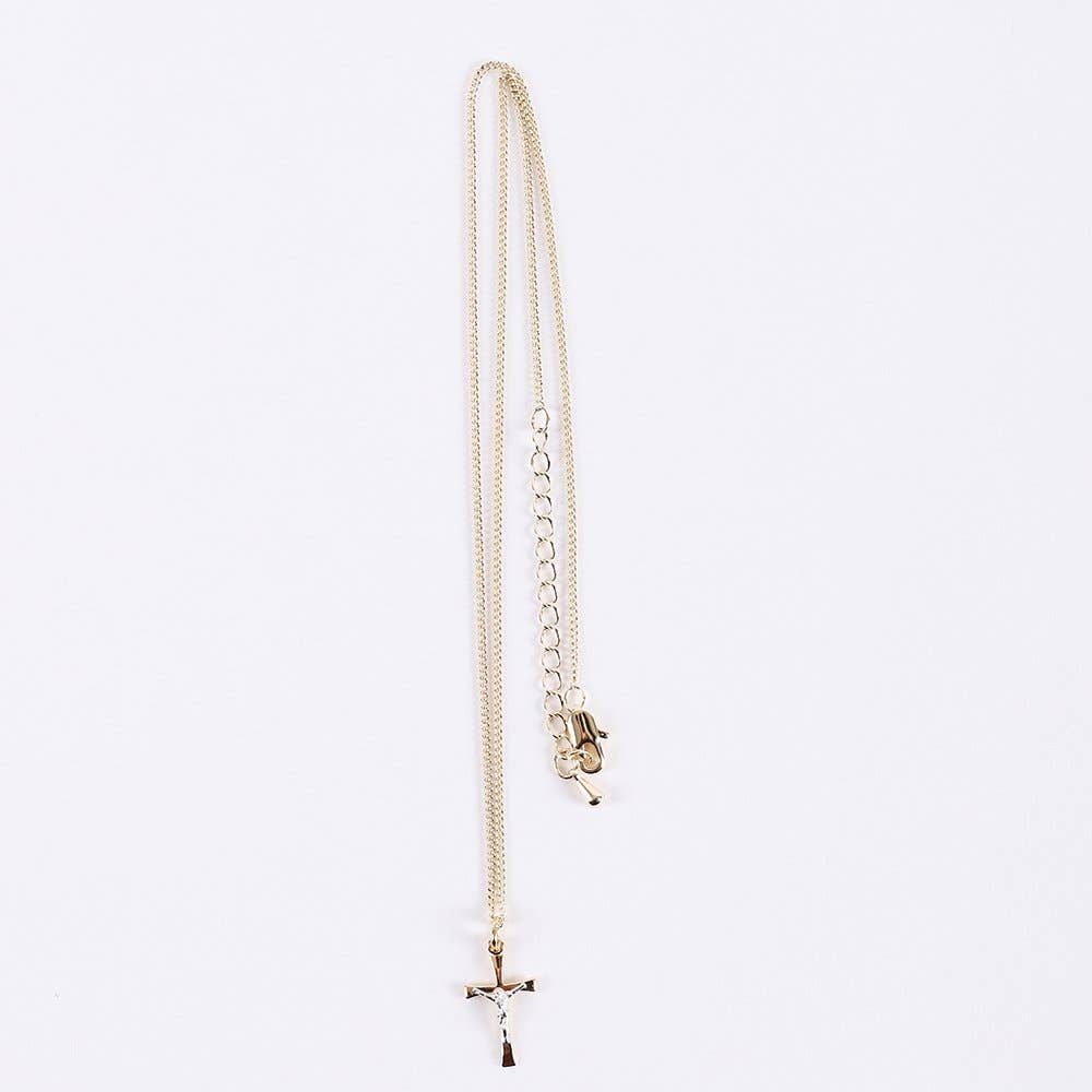 Gold necklace with a small pendant on a light gray background