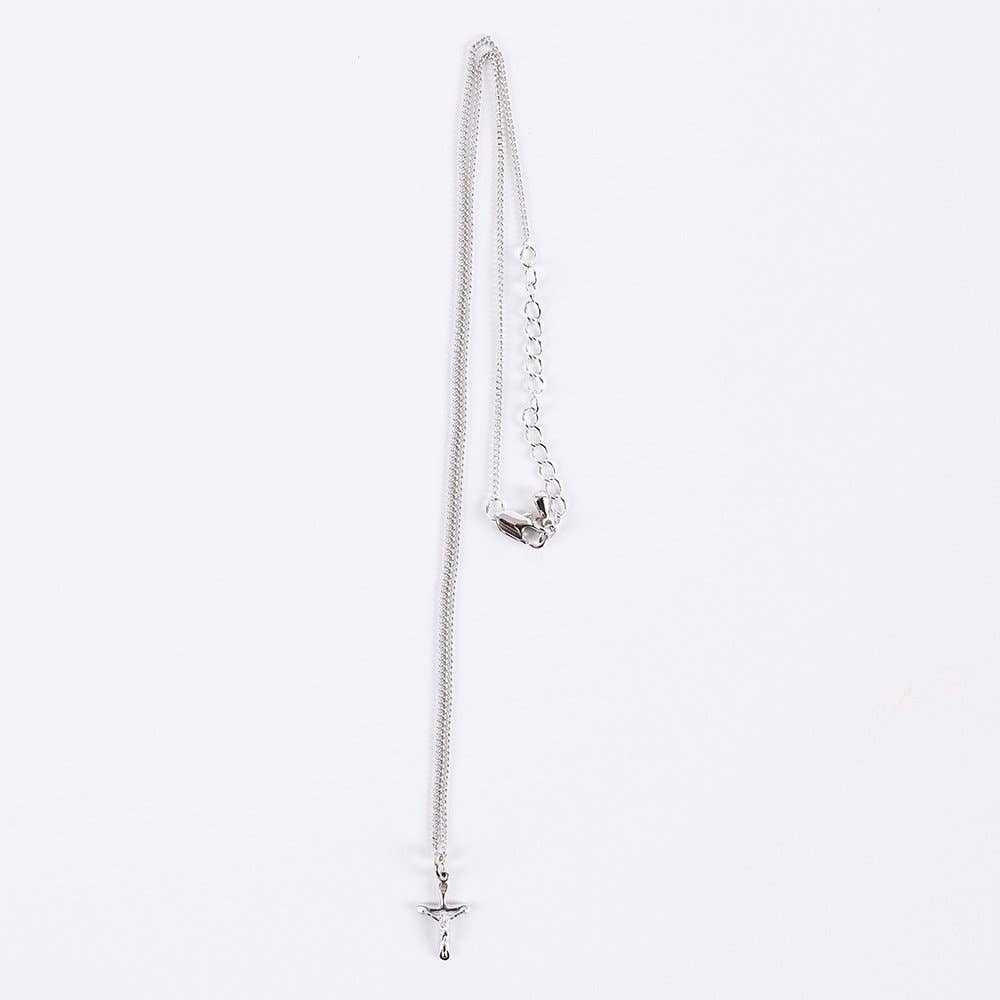 Silver necklace with a star pendant on a light gray background
